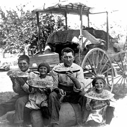 The John W. Mathews family (left) stop for a rest on their two-week trek via horse-drawn 'hack' from their homestead near Buhl, Idaho, to their permanent home in Pullman. It was the summer of 1910. Pictured from the left are Homer Hamilton Mathews, 14; Charlotte, 7; Catherine's father, John Wilbur Mathews; and 9-year-old Catherine. Her mother, Serena Wallis Mathews, took the photo, developed the negative, and made the print. She learned photography through a course at Washington State College.