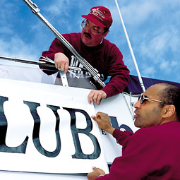 Tom Wilson and Rueben Mayes secure the Cougar Yacht Club banner. Robert Hubner