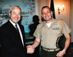 Lt. Col. Kurt Stinemetz (right) greets Jim Ellard, chairman of the Royal Marines Association in London.