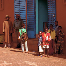 Children and the school guardian, Doro Jouri (in red beret), stand in front of the director's office at the Bimbilin Primary School in Ouahigouya, where Oumar Badini began his education. Peter Chilson
