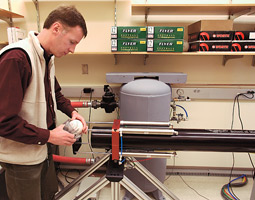With an air-powered gun, Lloyd Smith shoots softballs at bats to more accurately predict the bats' performance. Robert Hubner