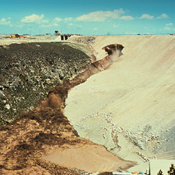 The hole in the dam face enlarges upward.