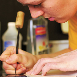 Catherine Parkay etches the plate for her engraving.