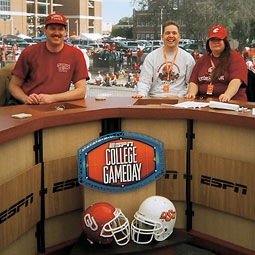 Tom Pounds '81 (left) visited the ESPN College Gameday set in Stillwater, Oklahoma, on November 2, 2004, with friends Malachi and Suzi Morgan.