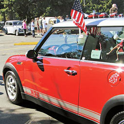 Cougs on the move: Wayne and Barb Bradford '58 of La Conner make their statement of school spirit in a crimson 'Cougar Cooper.'
