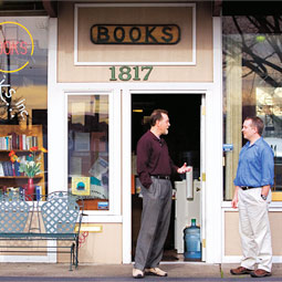 Bookstore owner Clyde Holloway '73 steps out the door of So Many Books to visit with a friend. His Vancouver bookstore like the shops of many other independent booksellers, is a fixture in the community.
