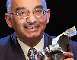 Professor Yogendra Gupta ('72 PhD Phys.), head of the Institute for Shock Physics and recipient of WSU's Eminent Faculty Award, holds the mangled remains of a projectile that was fired through the lab's four-inch gun.