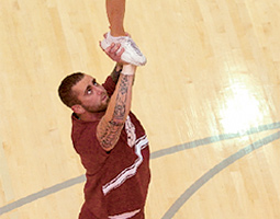 Don't try this at home: Cheerleader Chris Floe serves as the base for his partner, Amber Steadman, as she performs a heel stretch. It's one of dozens of lifts and throws he might do during a game. Don't try this at home: Cheerleader Chris Floe serves as the base for his partner, Amber Steadman, as she performs a heel stretch. It's one of dozens of lifts and throws he might do during a game.