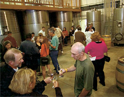 Rick Small '69 (below, right) mingles with guests at Woodward Canyon on spring release weekend in Walla Walla.