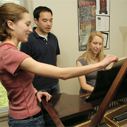 The first student resident of the Friel Music House five an impromptu performance around the Friel family's grand piano. The first student resident of the Friel Music House five an impromptu performance around the Friel family's grand piano.