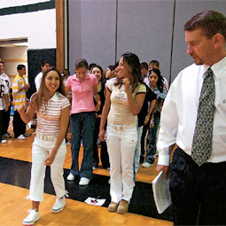 Principal Steve Pointer '88 leads the new freshmen in a walk across the gym in a practice graduation ceremony held the first week of school.