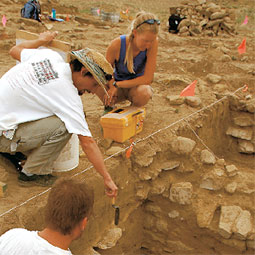 WSU assistant professor Andrew Duff (with the hat) urges his students to proceed carefully as they uncover the floor of a kiva.