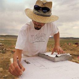 While supervising students, Andrew Duff carefully drafts a site plan for his own use and for future archaeologists who want to learn from the Cox Ranch dig.