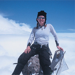 Fisher sits on the summit of Mount Elbrus of the Caucasus Range in Russia. In 2003, she summitted this, the highest peak in Europe.