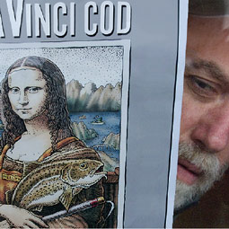 Troll peers from behind a poster advertising his 'DaVinci Cod' t-shirts at a Ketchikan gift shop.