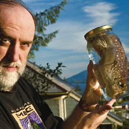 Troll holds a ratfish specimen on the deck of his studio overlooking the Tongass Narrows.