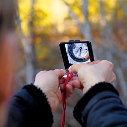 Cooley checks her bearing with a compass.