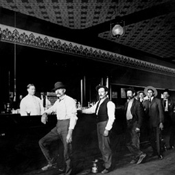 Men drink beer in an Okanogan establishment ca. 1909.