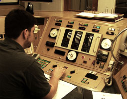 Senior Mathew King at the controls of the
university's 1.0 megawatt reactor. <em>Video still by Matthew Haugen</em>
