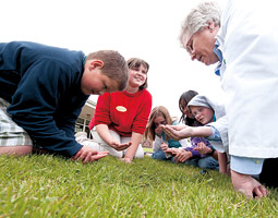 USDA soil microbiologist Ann Kennedy initiates students at the Guardian Angel-St. Boniface School in Colton in the wonders of soil microbial diversity. <em>Robert Hubner</em>