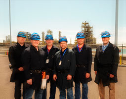 Kirt Johnson ’94, ’96, Jason Michelbook ’99, Colin Connacher ’90, Curtis Robillard’89, Jeff Johnson ’92, ’94, and Ron Reis ’80 at the Renewable Energy Corporation silicon plant in Moses Lake. <em>Robert Hubner</em>