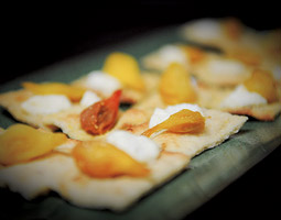 An appetizer from the meal featuring house-made grilled flatbread with fresh goat cheese and roasted teardrop tomatoes. <em>Zach Mazur</em>