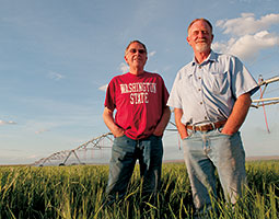 Orman Johnson '69 (left) and brother Gavin, who farm near Othello, irrigate from deep wells. Photo Zach Mazur