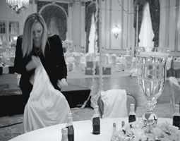 Dana Schroader '07, catering sales manager, helps set up a wedding in the historic Spanish Ballroom at the Fairmont Olympic Hotel in Seattle. by Crystal Toreson
