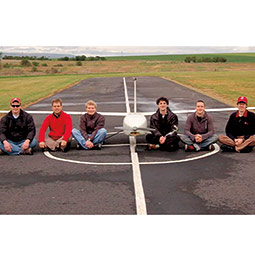 Jacob Leachman, left, and the student group that designed and built the pilotless aircraft Genii, which they flank. <em>Courtesy WSU HYPER Lab</em>