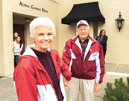 Sorority alumna Martha Copp leads husband Howard ’57 away from the Alpha Gamma Delta house as members (from left) Lexi Knutzen, Mia Portuese, and Kirsten Fischer look on. <em>Photo Shelly Hanks</em> Sorority alumna Martha Copp leads husband Howard ’57 away from the Alpha Gamma Delta house as members (from left) Lexi Knutzen, Mia Portuese, and Kirsten Fischer look on. <em>Photo Shelly Hanks</em>