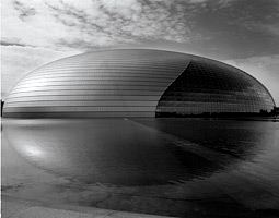 The National Theater in Beijing, an enormous domed structure which houses several theaters and is surrounded by a continuous moat of water.