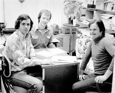 Founding Funksters: In 1997 KZUU's first leaders—Jon Etherton '78 (left), Bill Stewart '78 (center), and Henry Huestis '79—hold an early meeting in advisor Bob Searfoss's office. Photo by Robert Searfoss.